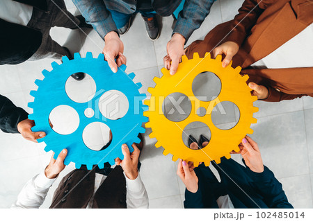 Business team work together and combine pieces of gears. Partnership and integration concept 102485014