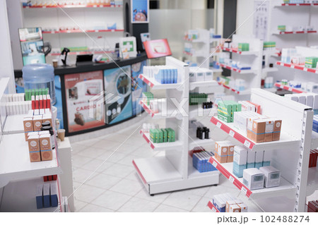 Empty pharmacy with nobody in it equipped with pharmaceutical products, health care products, vitamins. Drugstore desk full with medical prescription of customers. Medicine support services Empty pharmacy with nobody in it equipped with pharmaceutical products, health care products, vitamins. Drugstore desk full with medical prescription of customers. Medicine support services 102488274