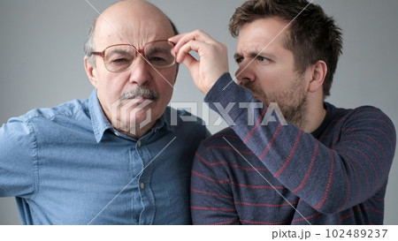 Surprised stupefied men mature father and son in big glasses with WOW expression 102489237