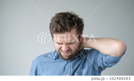 Caucasian man has neck and shoulder pain. Caucasian man has neck and shoulder pain. 102489263