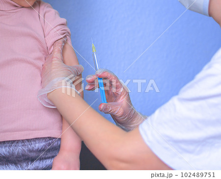 Little child is vaccinated by the doctor. 102489751