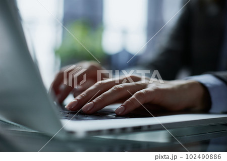 Close-up of male hands using laptop at office Close-up of male hands using laptop at office 102490886