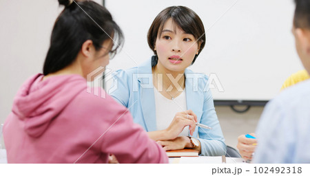 teacher in adult education class 102492318
