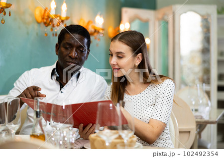 Adult couple on romantic date drinking red wine at restaurant 102492354