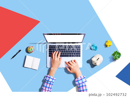 Laptop computer with a piggy bank and office objects 102492732