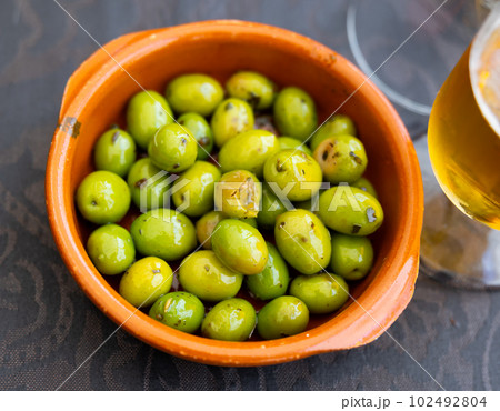 Portion of whole marinated olives 102492804