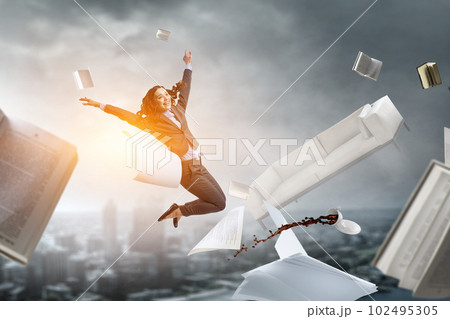Portrait of energetic businesswoman jumping in open air Portrait of energetic businesswoman jumping in open air 102495305