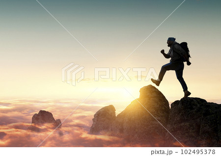 Male backpacker walking in mountains 102495378