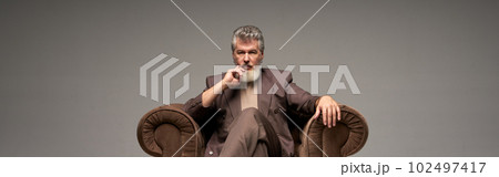 Full length shot of pensive mature businessman with beard wearin 102497417