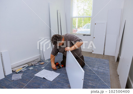 Process installing and assembling furniture closet cabinets with help of handyman 102500400