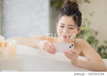 女性 ビューティー 入浴しながらスマホを見る若い女性 女性 ビューティー 入浴しながらスマホを見る若い女性 102501294
