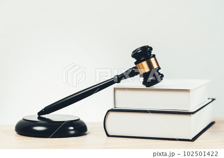 Black wooden gavel and book on office desk as justice and legal. equility 102501422