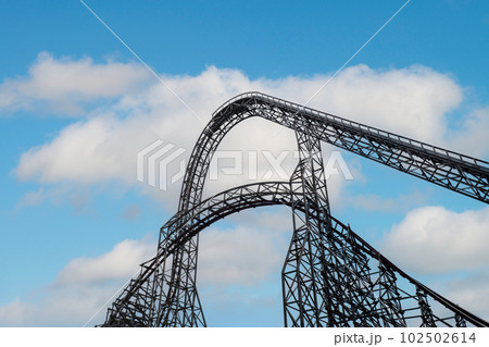 Riding the roller coaster at Energylandia Zator Poland amusement park. Solar powered roller coaster. Rollercoaster against blue sky Wooden outdoor leisure family Riding the roller coaster at Energylandia Zator Poland amusement park. Solar powered roller coaster. Rollercoaster against blue sky Wooden outdoor leisure family 102502614