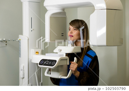 Female patient having computer tomography of jaw 102503790