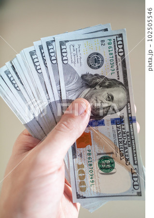 Close up male hand Counting and holding money us dollar. 102505546