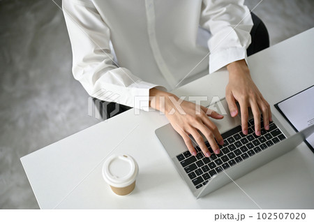 Top view of a businessman using laptop computer at a coffee shop. Top view of a businessman using laptop computer at a coffee shop. 102507020
