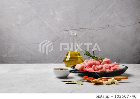 Ceramic pan with uncooked pork fillet chopped on cubes Ceramic pan with uncooked pork fillet chopped on cubes 102507746