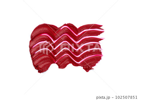 Red lipstick swatch isolated on white background. Brush stroke of lipstick or wet eye shadow for design. Red lipstick swatch isolated on white background. Brush stroke of lipstick or wet eye shadow for design. 102507851