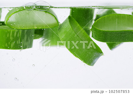 Sliced aloe vera in the water with water drops. Aloe vera slices in aloe vera gel. Sliced aloe vera in the water with water drops. Aloe vera slices in aloe vera gel. 102507853
