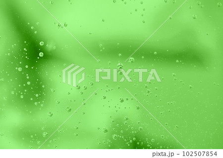 Water drops on green background. Abstract water bubbles on glass over green. 102507854