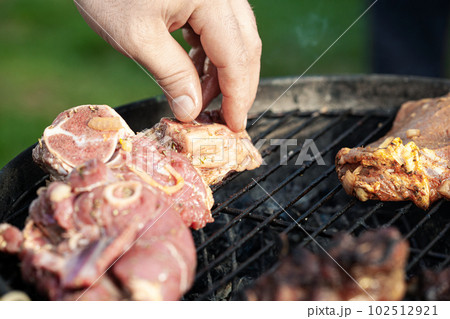 Cooking different meat on barbecue. Grilled and roasted lamb steaks on bbq. Take one piece Cooking different meat on barbecue. Grilled and roasted lamb steaks on bbq. Take one piece 102512921
