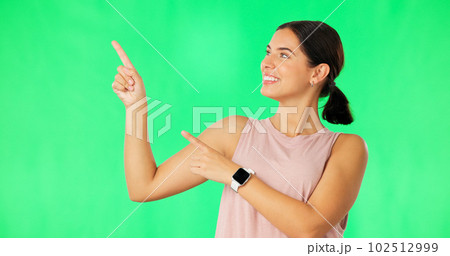 Woman face, hands pointing and green screen with happiness and smile showing advertisement. Portrait, isolated and studio background with a happy young female point to show mock up announcement 102512999