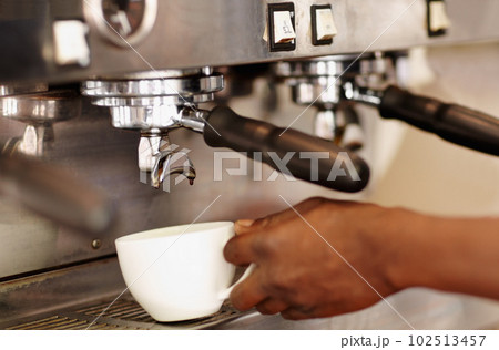 Hand, woman barista using coffee machine and expresso or latte being made. Closeup, female waiter working in restaurant or cafeteria and cup with brewing process making a hot drink or beverage Hand, woman barista using coffee machine and expresso or latte being made. Closeup, female waiter working in restaurant or cafeteria and cup with brewing process making a hot drink or beverage 102513457