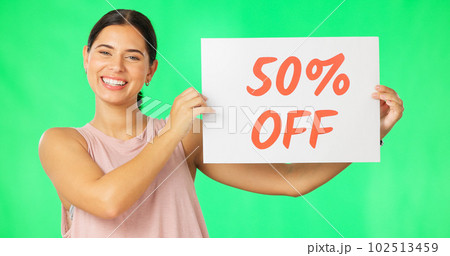 Woman, portrait and sale sign on green screen advertising percentage or discount rate on paper or banner. Smile of a happy female on a studio background for promotion deal, savings or deal and offer 102513459