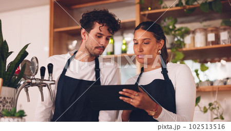 Barista team, talking with tablet in coffee shop, man and woman, discussion about work schedule or inventory check. Communication, technology with online system in cafe, working and manage sales 102513516