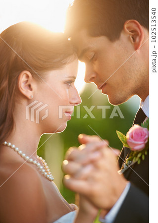 Dancing to their song. Intimate image of a newlywed couple dancing and looking into each others eyes. 102513540