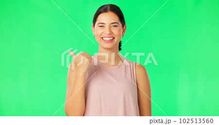 Woman face, pointing and green screen with happiness and smile showing mockup for advertisement. Portrait, isolated and studio background with a happy young female point to show mock up announcement Woman face, pointing and green screen with happiness and smile showing mockup for advertisement. Portrait, isolated and studio background with a happy young female point to show mock up announcement 102513560