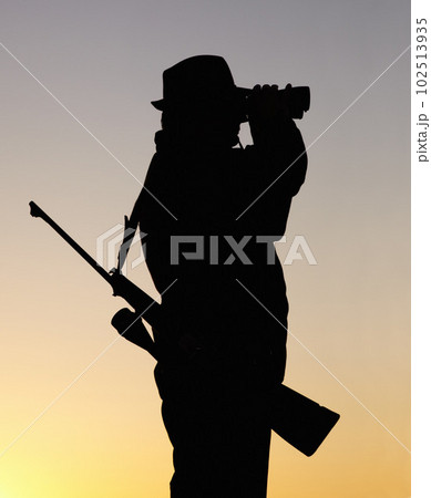 Hunting at sunset, man with gun and binoculars in nature to hunt game for sport on safari adventure. Sky, silhouette and hunter with rifle, search and setting sun for shooting hobby on summer evening Hunting at sunset, man with gun and binoculars in nature to hunt game for sport on safari adventure. Sky, silhouette and hunter with rifle, search and setting sun for shooting hobby on summer evening 102513935