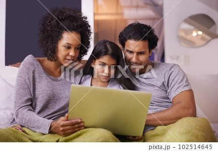 Its movie time. a loving young family watching something on a laptop at home. Its movie time. a loving young family watching something on a laptop at home. 102514645