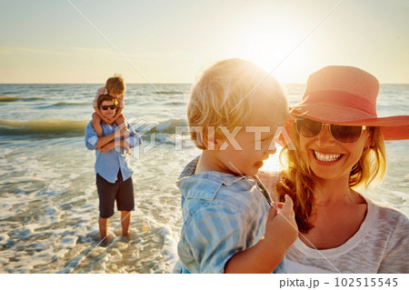 Family time, sunshine and fun times. a young family enjoying a day at the beach. 102515545