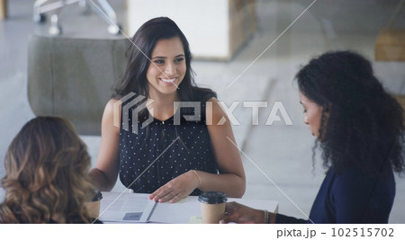 Theyre making great progress. High angle shot of three young businesswoman sitting in the boardroom during a management meeting. 102515702
