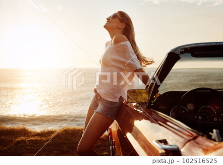 Ocean air and wind in your hair. a happy young woman enjoying a summers road trip. Ocean air and wind in your hair. a happy young woman enjoying a summers road trip. 102516525