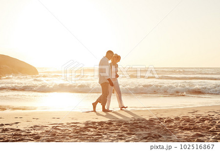 Romance never gets old. Full length shot of an affectionate middle aged couple walking hand in hand along the beach at sunset. Romance never gets old. Full length shot of an affectionate middle aged couple walking hand in hand along the beach at sunset. 102516867