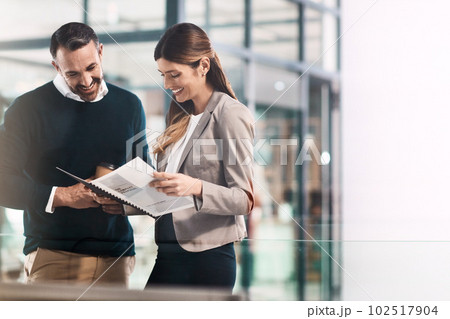The numbers dont lie. a businessman and businesswoman discussing paperwork in a modern office. The numbers dont lie. a businessman and businesswoman discussing paperwork in a modern office. 102517904