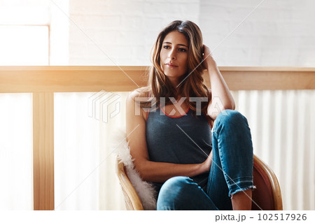 Invest in some time just by yourself. an attractive young woman relaxing at home. 102517926