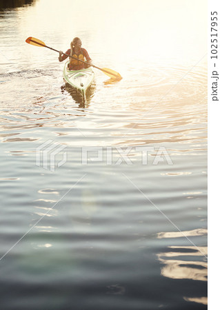 Having fun while getting a little workout. an attractive young woman out for canoe ride on the lake. Having fun while getting a little workout. an attractive young woman out for canoe ride on the lake. 102517955