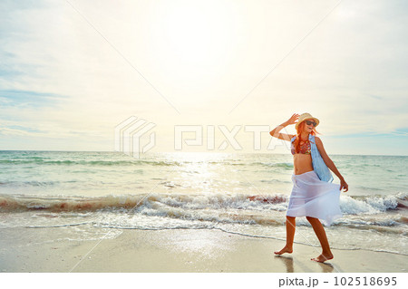 The biggest smiles are made in summer. Shot an attractive young woman enjoying a day at the beach. The biggest smiles are made in summer. Shot an attractive young woman enjoying a day at the beach. 102518695