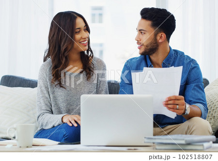 Now what paid secrets of yours will I find here. a happy young couple sitting on the sofa while going through paperwork in their lounge. Now what paid secrets of yours will I find here. a happy young couple sitting on the sofa while going through paperwork in their lounge. 102518807