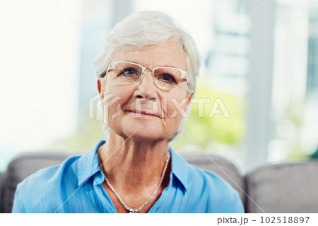 Content in my retirement. Cropped portrait of a senior woman sitting on her sofa at home. 102518897