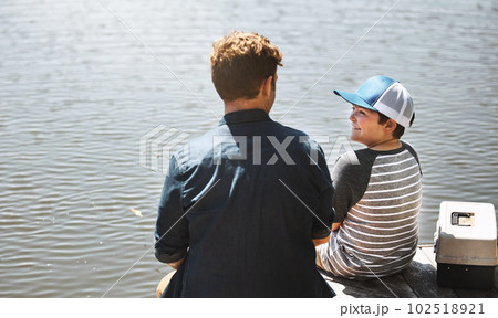 I wonder what our catch of the day will be. Rear view shot of a father and his little son fishing together. 102518921
