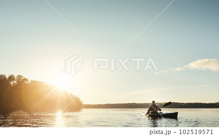 Everything you need. a young man kayaking on a lake outdoors. Everything you need. a young man kayaking on a lake outdoors. 102519571