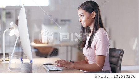 Portrait of a female psychologist working online and making appointment notes in her calendar. One young professional therapist planning, checking and filing out medical information on her computer 102520276