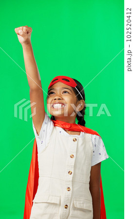 Costume, face and child in a studio with green screen doing a superhero pose and outfit. Happy, smile and portrait of a girl kid from Mexico in cosplay clothes by a chroma key background with mockup. 102520412