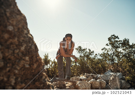 Little steps may be the beginning of a great journey. a young woman taking a break while out on a hike through the mountains. 102521043