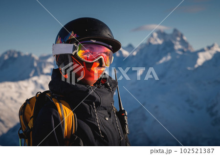 Skier smiling happy cheerful satisfied woman in warm windbreaker jacket ski goggles mask glasses spend extreme weekend in mountains on resort 102521387