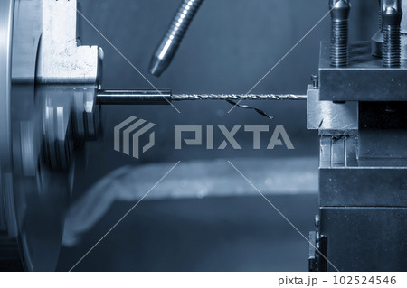 The CNC lathe machine make a hole on the small shaft parts with drilling tool. The CNC lathe machine make a hole on the small shaft parts with drilling tool. 102524546